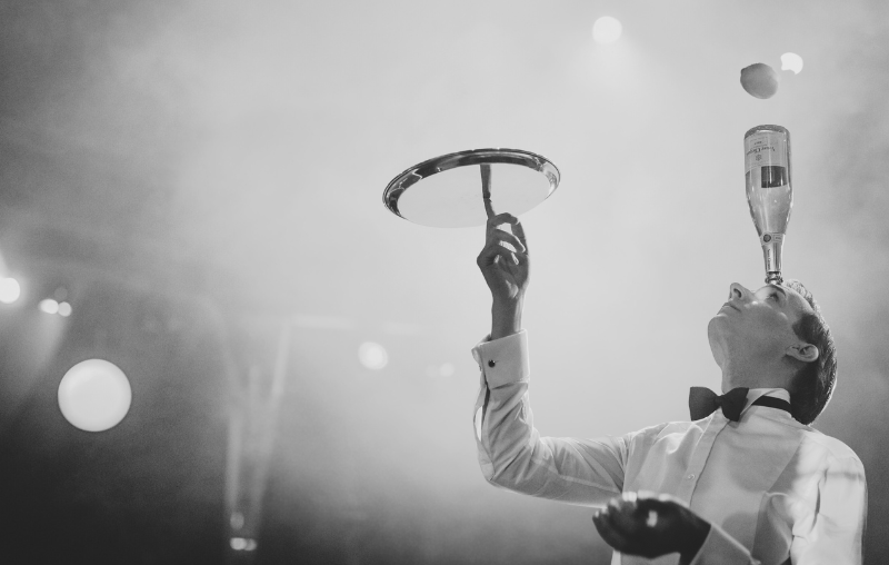 man juggling bottle in cabaret show at Upstairs at Manzi's show